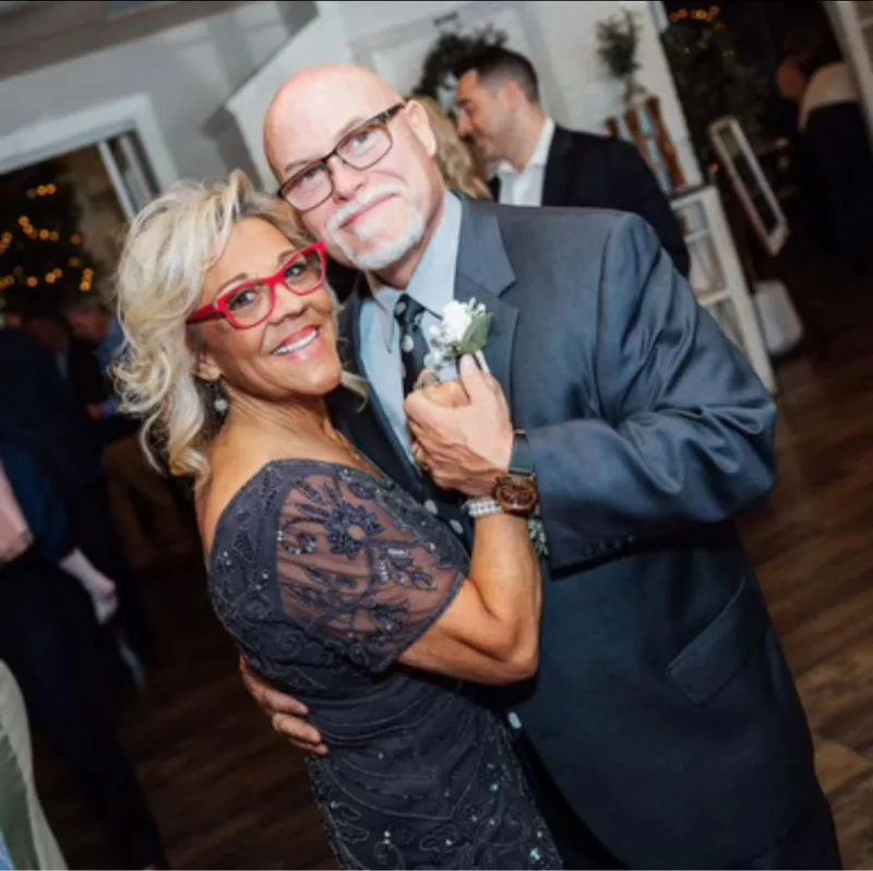 An older couple dressed up and dancing at a community event.