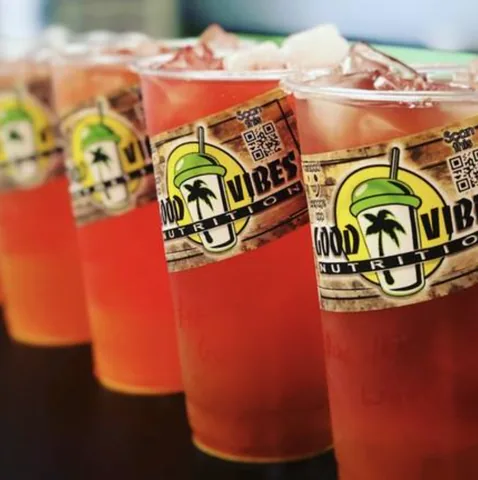 Four iced Good Vibes power teas in a row, each with a Good Vibes Nutrition sticker.